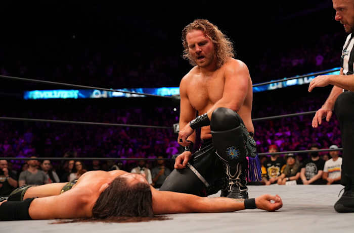 Hangman Page kneels over Adam Cole at AEW Revolution